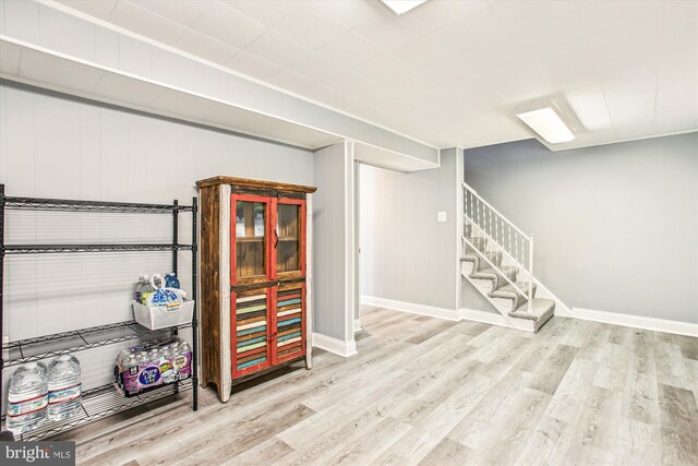 11910 Saint Johnsbury Ct, Reston, VA 20191 - finished basement featuring wood finished floors, baseboards, and stairway