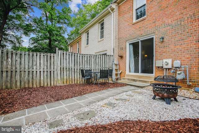11910 Saint Johnsbury Ct, Reston, VA 20191 - rear view of property featuring entry steps, a fenced backyard, brick siding, and a patio