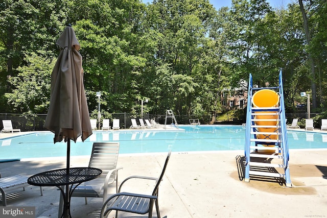 11910 Saint Johnsbury Ct, Reston, VA 20191 - community pool featuring a patio area and view of wooded area