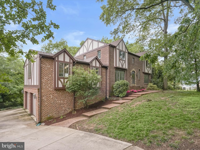 1316 Swan Harbour Rd, Fort Washington, MD 20744 - view of front of house with a garage, brick siding, driveway, and a front yard