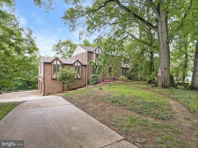 1316 Swan Harbour Rd, Fort Washington, MD 20744 - view of home's exterior with brick siding, concrete driveway, and board and batten siding