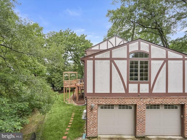 1316 Swan Harbour Rd, Fort Washington, MD 20744 - view of home's exterior with brick siding, a deck, a garage, and a lawn