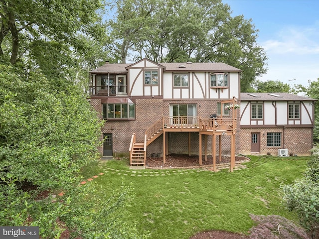 1316 Swan Harbour Rd, Fort Washington, MD 20744 - rear view of house featuring brick siding, stairs, a sunroom, and a yard