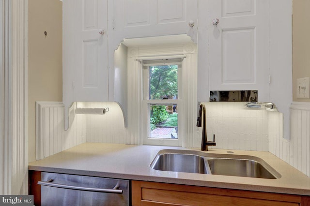 315 Nevin St, Lancaster, PA 17603 - kitchen featuring stainless steel dishwasher, a sink, tasteful backsplash, and white cabinetry