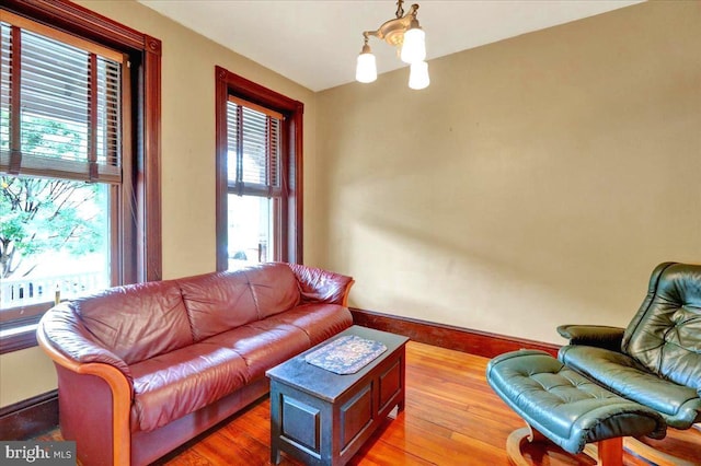 315 Nevin St, Lancaster, PA 17603 - living room featuring baseboards, wood finished floors, and a chandelier