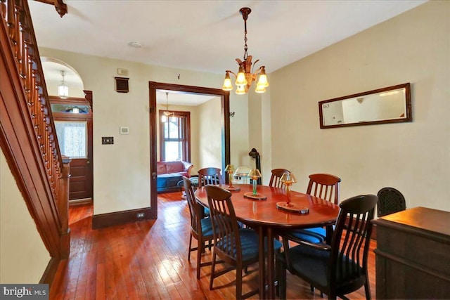 315 Nevin St, Lancaster, PA 17603 - dining area with dark wood-style floors, baseboards, a chandelier, and stairs