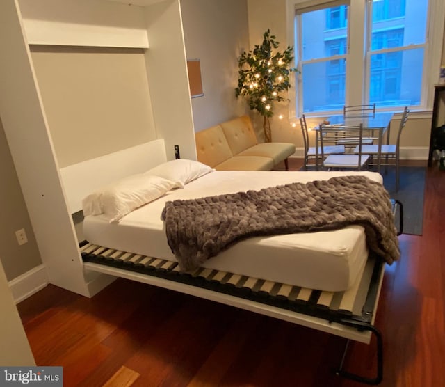 1121 24th St NW Unit 310, Washington, DC 20037 - bedroom with wood finished floors and baseboards
