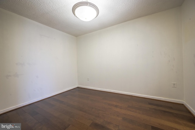 4500 Four Mile Run Dr Unit 211, Arlington, VA 22204 - spare room featuring dark wood-style floors, baseboards, and a textured ceiling