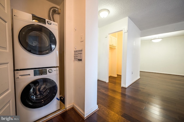 4500 Four Mile Run Dr Unit 211, Arlington, VA 22204 - laundry room featuring stacked washer / dryer, baseboards, dark wood-style floors, and a textured ceiling