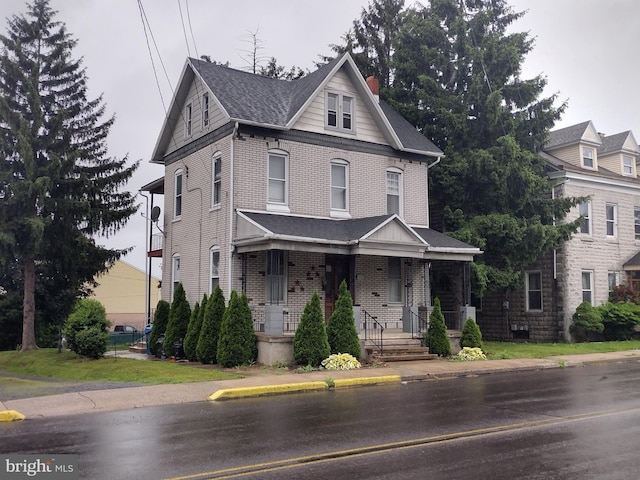 2926 Kutztown Rd, Reading, PA 19605 - view of front facade with brick siding, covered porch, and roof with shingles