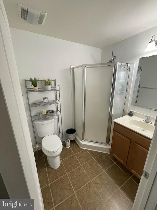 115 E Sheldrake Cir, Dover, DE 19904 - bathroom with vanity, toilet, a stall shower, and tile patterned floors