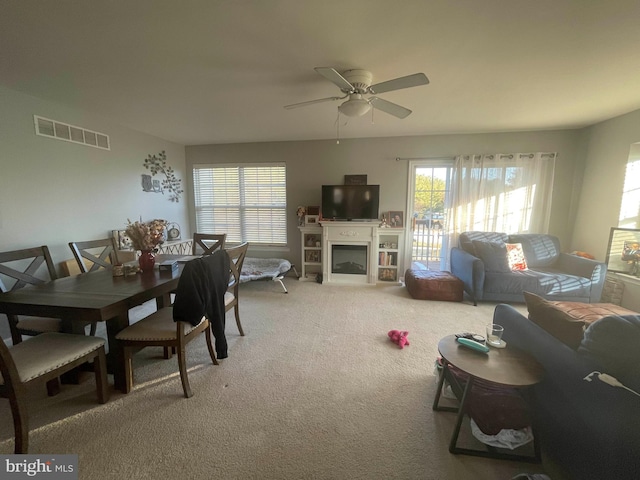 115 E Sheldrake Cir, Dover, DE 19904 - living room featuring light colored carpet, a ceiling fan, and a fireplace
