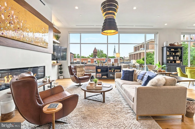 101 N Queen St Unit 409, Lancaster, PA 17603 - living room featuring wood finished floors, recessed lighting, and a glass covered fireplace