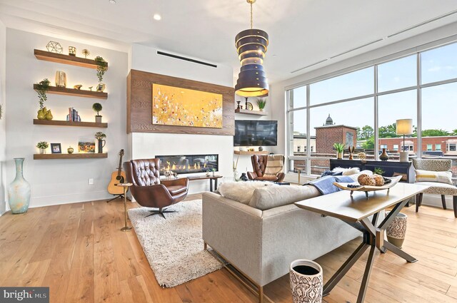 101 N Queen St Unit 409, Lancaster, PA 17603 - living room featuring light wood-style floors, a glass covered fireplace, baseboards, and recessed lighting