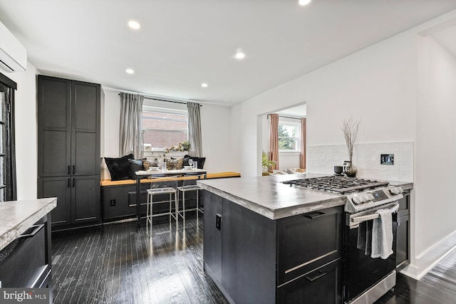5319 Ames St NE, Washington, DC 20019 - kitchen featuring stainless steel range with gas stovetop, dark cabinets, plenty of natural light, and recessed lighting