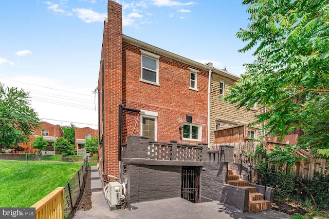 5319 Ames St NE, Washington, DC 20019 - rear view of house featuring brick siding, a cooling unit, a chimney, and stairs