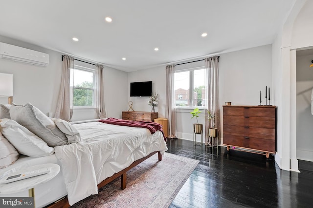 5319 Ames St NE, Washington, DC 20019 - bedroom featuring an AC wall unit, recessed lighting, baseboards, and wood finished floors
