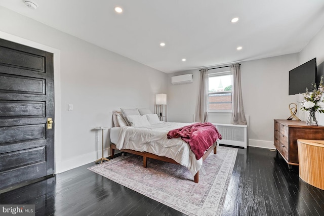 5319 Ames St NE, Washington, DC 20019 - bedroom with a wall mounted air conditioner, baseboards, radiator, wood finished floors, and recessed lighting