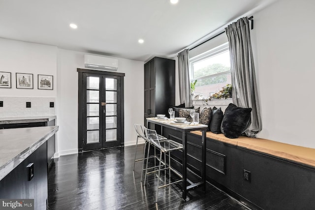 5319 Ames St NE, Washington, DC 20019 - dining room featuring a wall mounted air conditioner, dark wood-style floors, french doors, recessed lighting, and baseboards