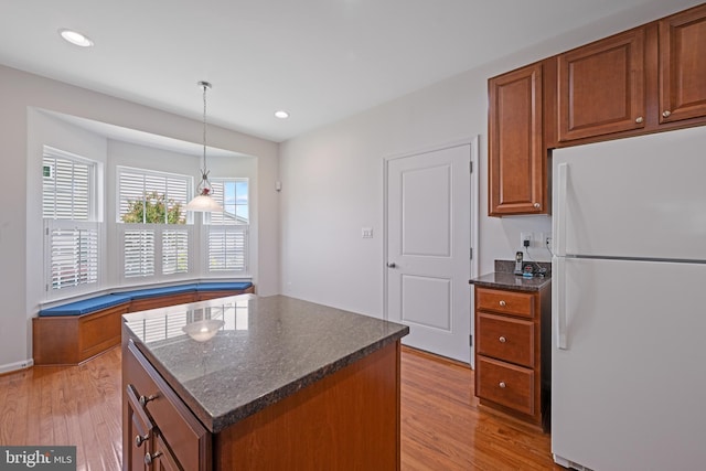 2342 Adam David Way, Marriottsville, MD 21104 - kitchen with freestanding refrigerator, brown cabinets, light wood-style flooring, recessed lighting, and a kitchen island