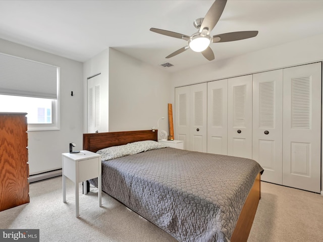 52 Circle Dr, Ephrata, PA 17522 - bedroom featuring light carpet, a baseboard radiator, ceiling fan, and two closets