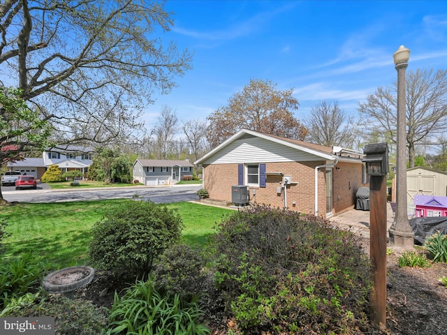 52 Circle Dr, Ephrata, PA 17522 - view of property exterior with brick siding, cooling unit, and a lawn