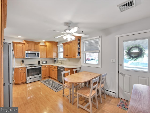 52 Circle Dr, Ephrata, PA 17522 - kitchen featuring appliances with stainless steel finishes, recessed lighting, a baseboard radiator, light countertops, and light wood-style floors