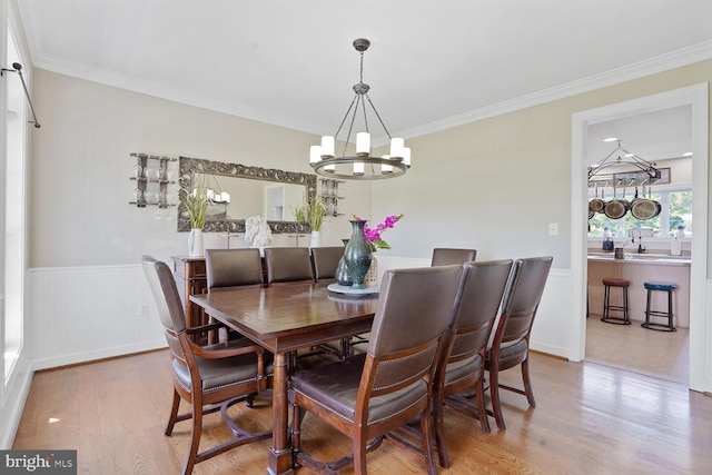5040 Hummingbird Ln, Warrenton, VA 20187 - dining room featuring a chandelier, wood finished floors, a wainscoted wall, and crown molding