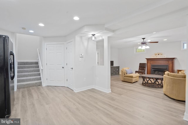 5040 Hummingbird Ln, Warrenton, VA 20187 - living room with stairs, light wood-type flooring, a glass covered fireplace, recessed lighting, and baseboards