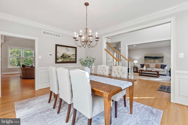 11 Woods Edge Rd, West Chester, PA 19382 - dining area with a chandelier, light wood-type flooring, crown molding, stairway, and wainscoting