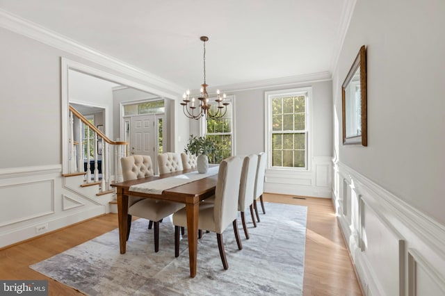 11 Woods Edge Rd, West Chester, PA 19382 - dining room with a chandelier, ornamental molding, a decorative wall, light wood-type flooring, and a wainscoted wall