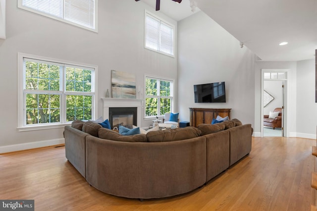 11 Woods Edge Rd, West Chester, PA 19382 - living area with a high ceiling, baseboards, a glass covered fireplace, light wood-style flooring, and recessed lighting