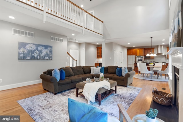 11 Woods Edge Rd, West Chester, PA 19382 - living room with a high ceiling, light wood-style flooring, baseboards, recessed lighting, and stairway
