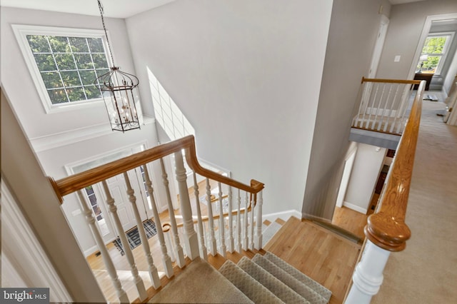11 Woods Edge Rd, West Chester, PA 19382 - stairway with a chandelier, baseboards, and wood finished floors