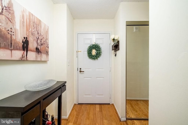 1600 N Oak St Unit 324, Arlington, VA 22209 - entryway with light wood-style flooring, baseboards, and a textured ceiling
