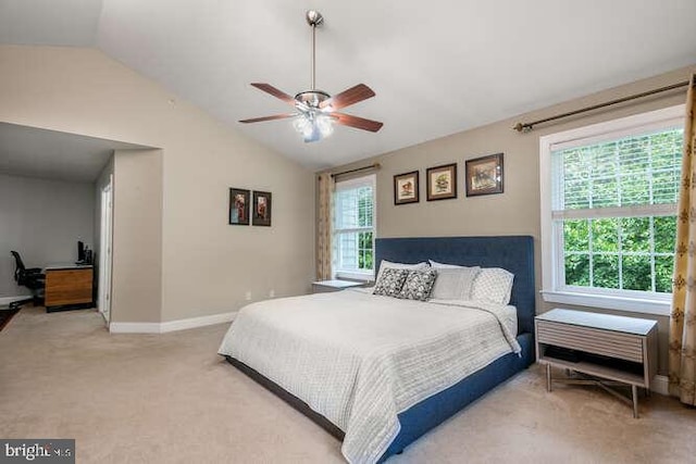 bedroom with vaulted ceiling, light carpet, baseboards, and a ceiling fan