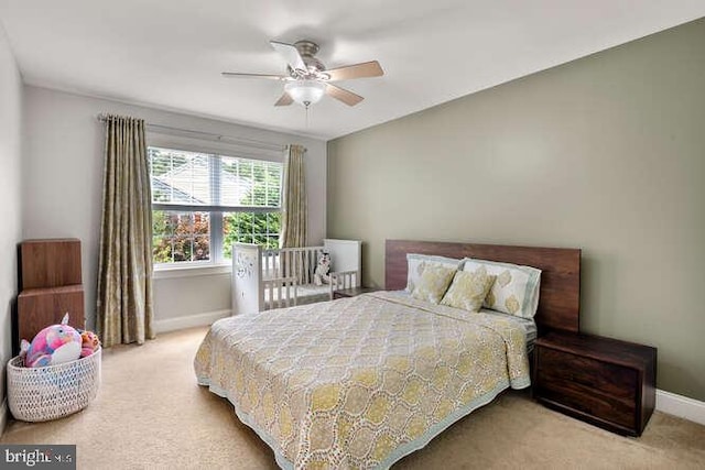 carpeted bedroom with baseboards and ceiling fan