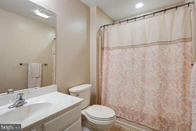 full bath featuring toilet, vanity, curtained shower, and tile patterned flooring