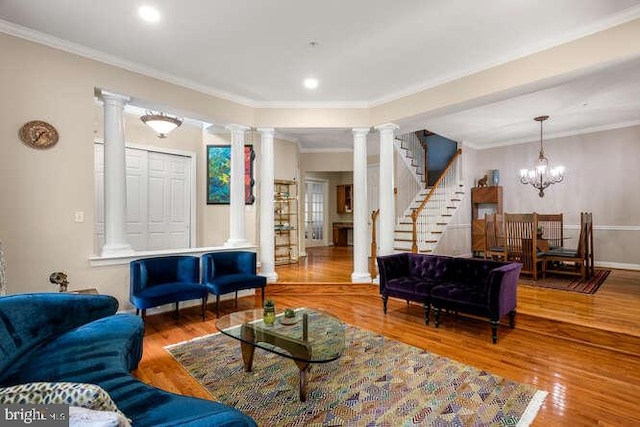 living room with ornate columns, crown molding, wood finished floors, recessed lighting, and stairway