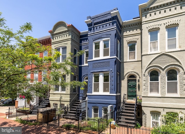 704 F St NE, Washington, DC 20002 - view of property featuring brick siding, a fenced front yard, and stairway