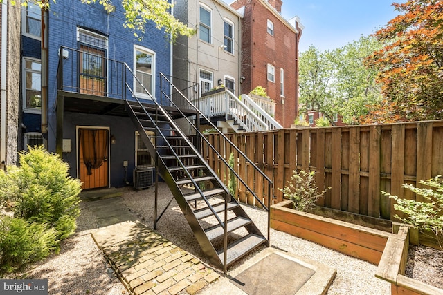 704 F St NE, Washington, DC 20002 - rear view of property featuring stairway, cooling unit, and brick siding