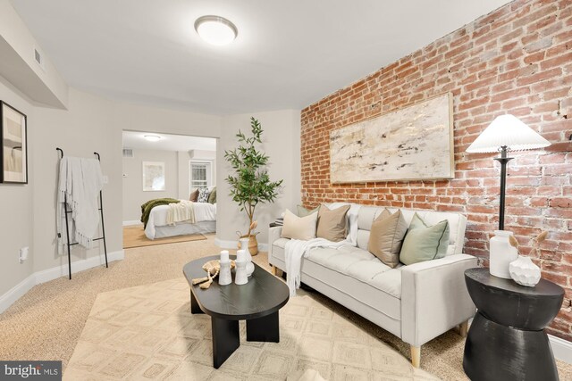 704 F St NE, Washington, DC 20002 - carpeted living room featuring brick wall and baseboards