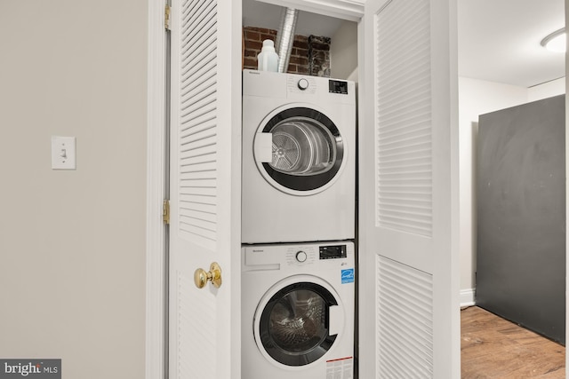 704 F St NE, Washington, DC 20002 - laundry area featuring stacked washing machine and dryer and wood finished floors