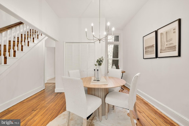 704 F St NE, Washington, DC 20002 - dining space with a chandelier, light wood-style floors, stairway, and baseboards