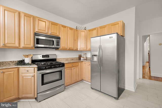 704 F St NE, Washington, DC 20002 - kitchen with appliances with stainless steel finishes, light brown cabinets, and light stone countertops