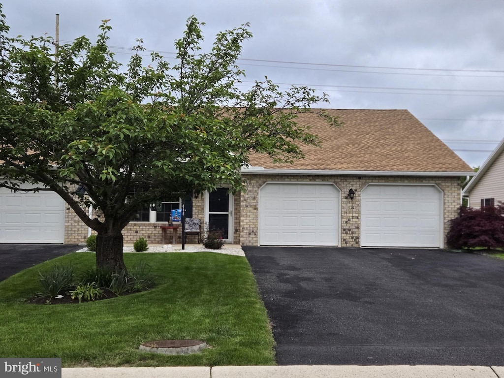 416 Kara Way, Shippensburg, PA 17257 - view of front facade with driveway, a garage, brick siding, a front yard, and roof with shingles