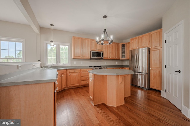143 Bakerfield Dr, Middletown, DE 19709 - kitchen with appliances with stainless steel finishes, light brown cabinets, wood finished floors, a kitchen island, and glass insert cabinets