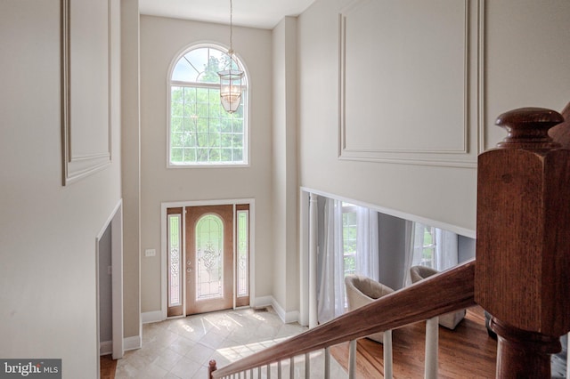 143 Bakerfield Dr, Middletown, DE 19709 - foyer entrance with a high ceiling, stairway, baseboards, and light tile patterned flooring