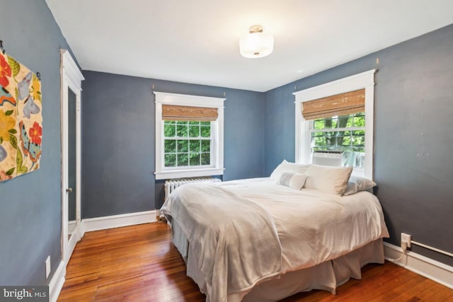 330 Wood Ln, Haddonfield, NJ 08033 - bedroom featuring wood finished floors, baseboards, cooling unit, and radiator