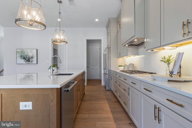 629 S Orange St, Media, PA 19063 - kitchen featuring a sink, appliances with stainless steel finishes, light wood finished floors, a kitchen island with sink, and light countertops